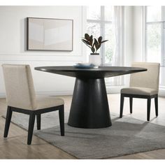 a dining room table with chairs and a rug on the floor in front of it