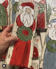 someone is painting santa claus on wood planks with paint and glue to make them look like they're coming out of the woods