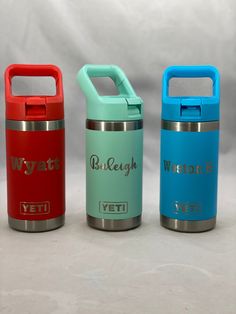 three different colored yeti bottles sitting next to each other