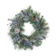 a christmas wreath with pine cones and blue berries