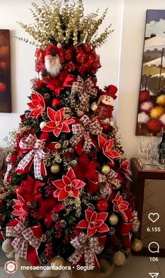 a christmas tree decorated with poinsettis and bows