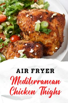 a white plate topped with meat and salad next to a paper napkin that says air fryer mediterraneanan chicken thighs