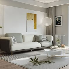 a living room with a couch, coffee table and pictures on the wall