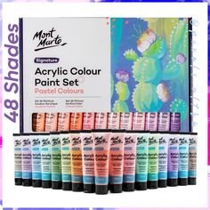 12 tubes of acrylic paint set in front of a colorful background with cactuses