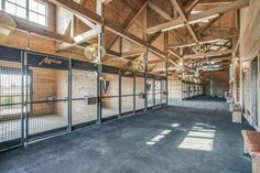 the inside of an empty building with lots of wood and glass doors on each side