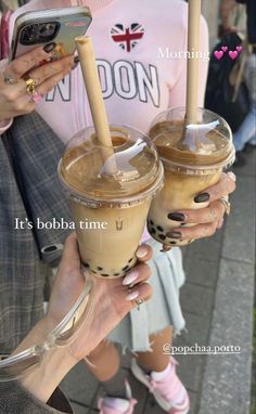 two people holding up drinks in front of their cell phones with the caption it's boba time