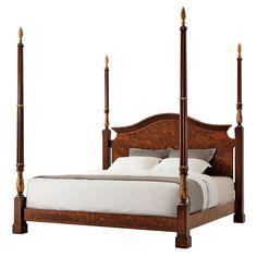 a bed with four posts and white sheets