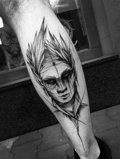 a man's leg with an artistic tattoo on it