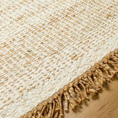 a close up view of a rug on the floor with some brown and white colors