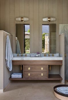 a large bathroom with two sinks and mirrors