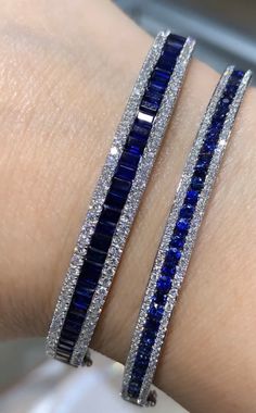 This eye-catching, blue sapphire & diamond bangle bracelet is a statement-making piece that stands well on its own, eliminating the need to stack bangles. Metal: 18K White GoldSapphire Weight: (38) Baguette-cuts 3.75ct twDiamond Shape , Weight: (90) Round Brilliant-cuts 1.29ct twBangle/Wrist Width: 5.7cm x 4.9cmBangle Weight: 7mm Estimated production time is 4 - 5 weeks. Stack Bangles, Sapphire Bangle, Custom Bangle, Gold Bangles For Women, White Gold Bangle, Diamond Bangle Bracelet, Diamond Pendant Sets, Diamond Necklace Set, Diamond Bangles Bracelet