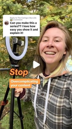 a woman standing in front of a tripod and holding up a sign that says stop over complicating your camera