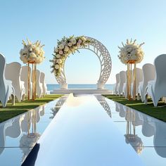 an outdoor ceremony set up with white chairs and flowers on the aisle, overlooking the ocean