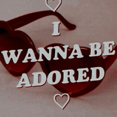 the words i love wanna be adored are cut out into heart shaped glasses