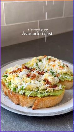 an avocado toast on a white plate