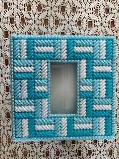 a small blue and white frame on a doily