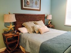 a bedroom with a bed, nightstands and pictures on the wall