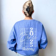 a woman with her back to the camera wearing a blue sweatshirt that says, seniors dance since 2 / 3