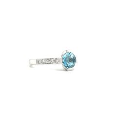 Elegantly made in 14K white gold, this modern aquamarine ring is perfect for both day and evening occasions. Its centerpiece, a marvelous 1.1ct round aquamarine, is bar set on four sides. The shank features 5 micro-prong diamonds on each side. With a polished to shine finish, all eyes will be on this exquisite aquamarine ring. 14K White Gold Aquamarine: 1- Round-shape with a total carat weight of 1.1ct Diamond: 10- Round-cut with a total carat weight of 0.28ct Polished Finish Finger Size: 7 White Gold Blue Topaz Ring With Tension Setting, Modern Blue Topaz Round Cut Ring, Modern Sapphire Ring With Blue Topaz Center Stone, Modern Topaz Ring With Prong Setting And Round Cut, Modern Blue Diamond Ring With Prong Setting, Modern White Gold Topaz Ring With Accent Stones, Modern White Gold Topaz Ring With Brilliant Cut, Blue Topaz Ring With Round Cut And Tension Setting, Classic Light Blue Diamond Ring