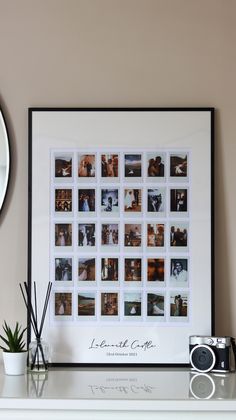 a white mantle topped with a framed photo and a camera next to a clock on top of it