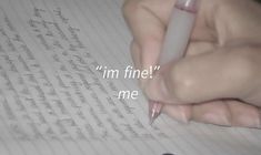 a person writing on paper with a pen in their hand and the words i'm fine