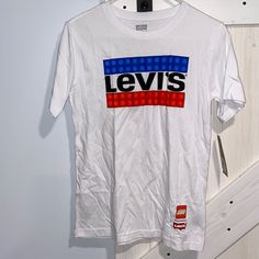 Levi’s Lego White Short Sleeve Tee Shirt. Size Large 12-13 Years. Nwt Never Worn. Slightly Wrinkled Due To Being Stored. See Pics. Levi's White Short Sleeve Shirt, Levi's White Cotton Top, Levi's White Relaxed Fit Shirt, Casual White Levi's Top, White Cotton Levi's Top, White Levi's T-shirt For Summer, Levi's White Relaxed Fit Top, Levi's White Graphic Print T-shirt, Levi's White Graphic Tee