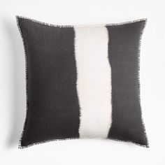 a black and white striped pillow on a white background with the same color as the pillows