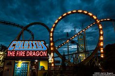 the fire dragon roller coaster is lit up at night