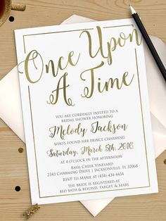 a white and gold one upon at time party card on top of some envelopes