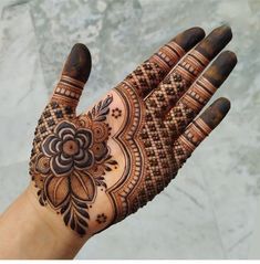 a person's hand with hennap on it, showing the intricate design