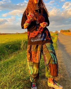 a woman standing on the side of a road