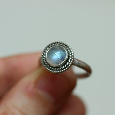 Playful and fun new western-style ring in Rainbow Moonstone and sterling silver. This is a perfect dainty southwestern ring with a twist - a double twist that is! Two .925 Sterling Silver graduated twist wires accent a 7mm Rainbow Moonstone cabochon. High-grade Rainbow Moonstone with a perfectly detailed, sterling silver setting. Super flashy rainbow moonstone ring!! Set in .925 sterling silver -- oxidized and burnished bezel and wire. Simple, elegant, and perfect. This lovely little ring is cre Adjustable Sterling Silver Moonstone Birthstone Ring, Adjustable Sterling Silver Stackable Moonstone Ring, Adjustable Stackable Moonstone Ring In Sterling Silver, Adjustable Stackable Sterling Silver Moonstone Ring, Bohemian Stackable Moonstone Ring In Sterling Silver, Western Ring, Western Rings, Double Twist, Opal Drop Earrings