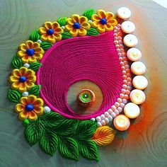 a table topped with candles and flowers on top of a wooden table next to a candle holder