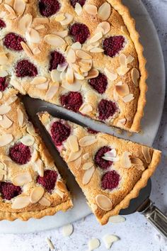 a pie with raspberries and almonds cut into slices