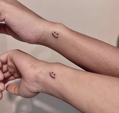 two people with small tattoos on their arms