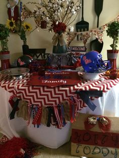 the table is decorated with red, white and blue decorations for an american football party