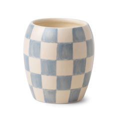 a blue and white checkerboard vase on a white background