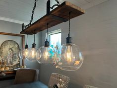 the lights are hanging from the ceiling in the dining room, which is decorated with glass globes