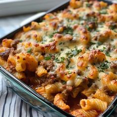 a casserole dish filled with pasta and meat