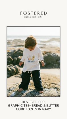 a little boy standing on top of a rock next to the ocean with text reading best sellers graphic tee, bread & butter cord pants in navy