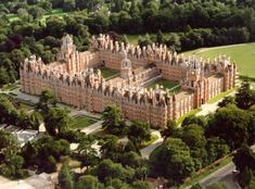 an aerial view of a castle with trees surrounding it