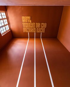 there is no finish line on the floor in an empty room with red walls and windows