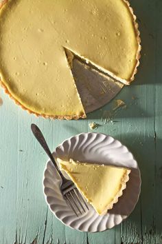 a piece of pie on a plate with a fork next to it and another slice missing