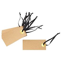 two brown tags with black string attached to them