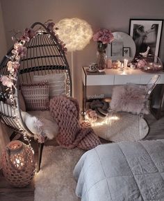 a bedroom with a birdcage bed and pink flowers on the pillow, lights in the background