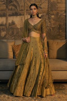 Moss green half sleeve padded blouse with antique gold cutdana, zardozi embroidery in scallop pattern. Paired with embroidered attached cancan lehenga and dupatta. 
Components: 3
Pattern: Embroidery
Type Of Work: Cutdana, zardozi, scallop
Neckline: Scallop V neck
Sleeve Type: Half sleeves
Fabric: Blouse and Lehenga: Tissue Silk, Dupatta: Net
Color: Green
Other Details: 
Model height: 5 ft 8 inches, wearing size XS
Lehenga:
Attached cancan
Length: 45 inches
Blouse:
Padded
Inverted V hem
Back tass Tissue Lehnga Design, Half Sleeves Blouse Designs Indian, Tissue Silk Lehenga Designs, Scallop Embroidery Dupatta, Tissue Lehanga Design, Cheap Lehenga, Traditional Lehenga Blouse Designs, Tissue Lehenga Designs, Tissue Fabric Lehenga