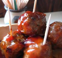 several meatballs with toothpicks in them on a plate