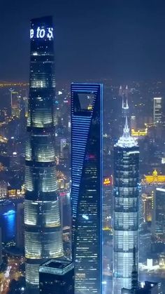 an aerial view of skyscrapers in the city at night, with chinese characters on top