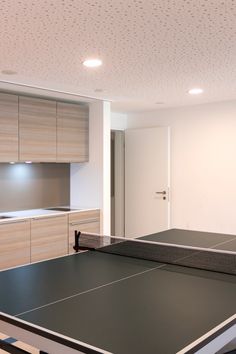 an indoor ping pong table in a kitchen