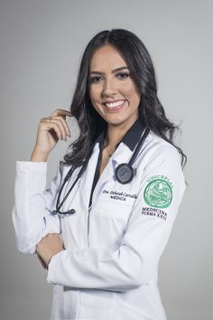 a woman wearing a white lab coat posing for a photo